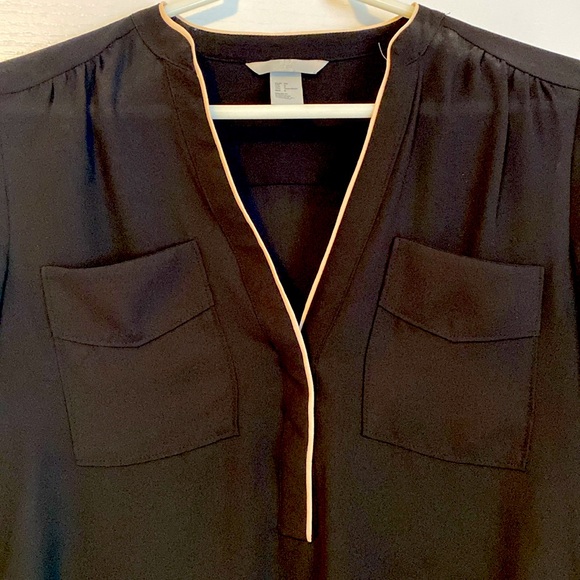 H&M black blouse with cream detailing. Front pockets. Button on sleeves. - Picture 2 of 4